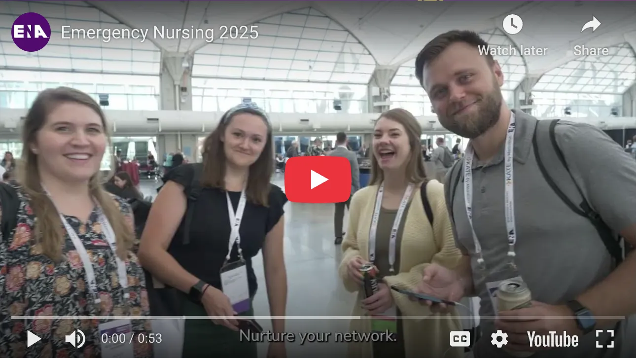 A group of four smiling conference attendees—three women and one man—stand together in a bright, spacious convention center with a high glass ceiling. They are wearing lanyards. The video title is "Emergency Nursing 2025".